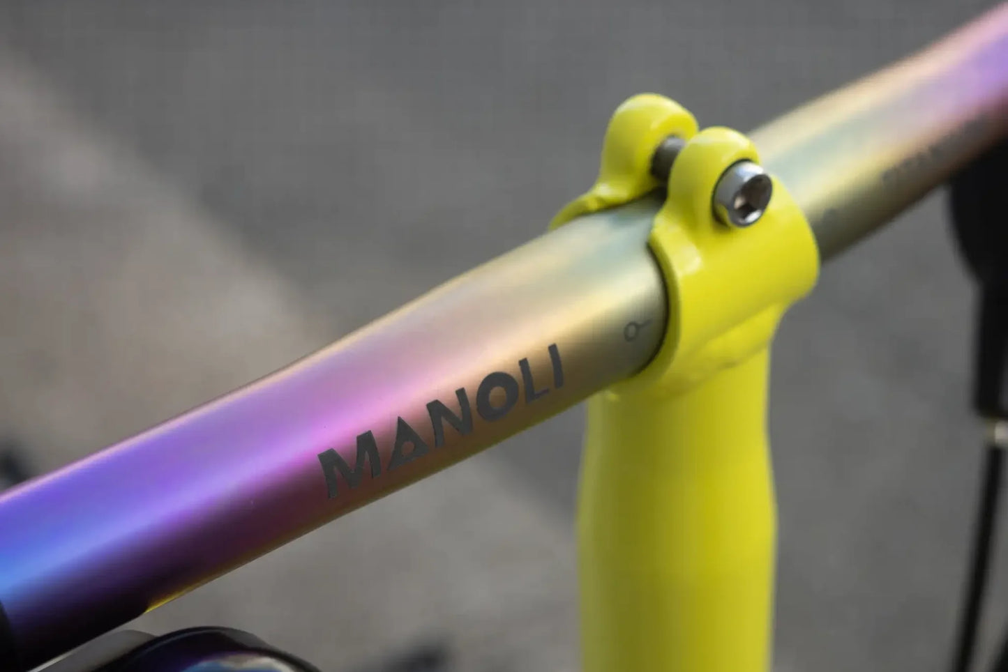 Manoli Titanlenker in der Farbe Rainbow an einem Gelben Brompton Vorbau